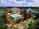 Captivating aerial view of a home nestled by a serene lake, boasting lush greenery and scenic surroundings at 407 Sheryl Dr, Deltona, FL 32738