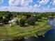 Gorgeous lakefront property with a house, lush greenery, and a peaceful setting at 407 Sheryl Dr, Deltona, FL 32738