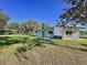Expansive backyard with lush green lawn, featuring a back door leading to a spacious outdoor area at 407 Sheryl Dr, Deltona, FL 32738
