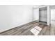 Clean bedroom with gray hardwood floors and sliding door closet for ample storage at 407 Sheryl Dr, Deltona, FL 32738