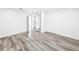 Bright bedroom with wood-look flooring and a mirrored closet at 407 Sheryl Dr, Deltona, FL 32738