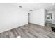 A well-lit room showcases wood floors and a door leading to the rest of the house at 407 Sheryl Dr, Deltona, FL 32738