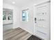 The front entrance features a modern door with decorative windows and durable vinyl floors inside at 407 Sheryl Dr, Deltona, FL 32738