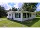 Beautiful single-story home featuring large windows, modern style, and lush green surroundings at 407 Sheryl Dr, Deltona, FL 32738