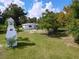 Charming single-story home featuring a unique lighthouse structure and lush green lawn at 407 Sheryl Dr, Deltona, FL 32738