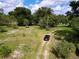 Overview of the property's green space, showing the driveway, mature trees, and serene surroundings at 407 Sheryl Dr, Deltona, FL 32738