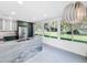 Modern kitchen featuring a gray waterfall island, stainless steel appliances, and a large window overlooking a spacious backyard at 407 Sheryl Dr, Deltona, FL 32738