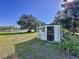 Side view of outbuilding by the lake with open door, window, and room for storage at 407 Sheryl Dr, Deltona, FL 32738