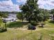 View of the driveway leading up to a single story home with a large lawn and mature trees on a sunny day at 407 Sheryl Dr, Deltona, FL 32738
