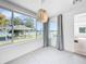 A sunny sunroom with views of the lake, has large windows and modern lighting at 407 Sheryl Dr, Deltona, FL 32738