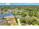 Stunning aerial view showcases the waterfront property with mature trees and skyline in the distance at 4210 Waterfront Pkwy, Orlando, FL 32806