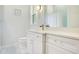 Bright bathroom featuring a white vanity, quartz countertop, gold faucet, and decorative lighting fixture at 4210 Waterfront Pkwy, Orlando, FL 32806