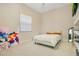 Neutral bedroom with a light-colored bed, white bedding, and a window bringing in natural light at 4210 Waterfront Pkwy, Orlando, FL 32806