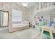 Charming bedroom with floral wallpaper, a cozy daybed, and a unique lofted play area at 4210 Waterfront Pkwy, Orlando, FL 32806