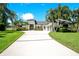 Elegant home with lush landscaping, expansive driveway, and modern architectural details at 4210 Waterfront Pkwy, Orlando, FL 32806