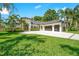 Beautiful modern home featuring manicured lawn, palm trees, and a spacious three-car garage at 4210 Waterfront Pkwy, Orlando, FL 32806