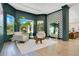 Stylish living room with designer furniture, large windows, and elegant hardwood flooring at 4210 Waterfront Pkwy, Orlando, FL 32806