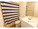 Bathroom featuring a sink and vanity, toilet, and blue-striped shower curtain at 4336 Cloverleaf Pl, Casselberry, FL 32707