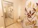 Compact bathroom with mirrored closet, toilet, tiled floor, and a shower-tub with curtain at 4336 Cloverleaf Pl, Casselberry, FL 32707