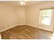 Bedroom with wood-look floors, neutral colors, ceiling fan, and sunny window views at 4336 Cloverleaf Pl, Casselberry, FL 32707
