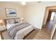 Staged bedroom with wood-look flooring, soft natural light, and a cozy queen bed at 4336 Cloverleaf Pl, Casselberry, FL 32707
