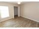 Cozy bedroom with neutral colors, wood-look floors, large closet, and bright sunny window at 4336 Cloverleaf Pl, Casselberry, FL 32707