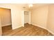 A bedroom is shown with wood floors, an open closet, and standard tan paint at 4336 Cloverleaf Pl, Casselberry, FL 32707