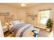 Bright bedroom with a ceiling fan, decorative shelves, wood floor and big window at 4336 Cloverleaf Pl, Casselberry, FL 32707