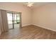 Bedroom featuring wood-look floors, neutral walls, ceiling fan, and large sliding glass doors at 4336 Cloverleaf Pl, Casselberry, FL 32707