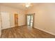 Bright bedroom with a ceiling fan, wood-look flooring, and sliding doors to the outside at 4336 Cloverleaf Pl, Casselberry, FL 32707