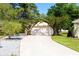 Charming home featuring a concrete driveway, 2-car garage, and beautiful landscaping with flowering trees at 4336 Cloverleaf Pl, Casselberry, FL 32707