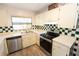 Bright kitchen featuring stainless appliances, checkerboard backsplash, and wood look tile floors at 4336 Cloverleaf Pl, Casselberry, FL 32707