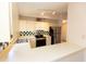 Kitchen featuring white countertops, white cabinets, checkerboard backsplash, and stainless steel appliances at 4336 Cloverleaf Pl, Casselberry, FL 32707