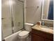 Bathroom features shower/tub with glass doors, granite countertop vanity, and tiled flooring at 4838 Pebble Beach Dr # A, Orlando, FL 32811