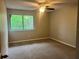 Bedroom featuring natural light from a window and neutral carpeting throughout the room at 4838 Pebble Beach Dr # A, Orlando, FL 32811