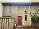 Charming townhome with a red front door and natural landscaping at 4838 Pebble Beach Dr # A, Orlando, FL 32811