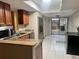 Updated kitchen with granite countertops, stainless steel appliances, and tile flooring at 4838 Pebble Beach Dr # A, Orlando, FL 32811