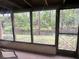 Enclosed porch area with a serene view of the lush backyard and waterfront at 4838 Pebble Beach Dr # A, Orlando, FL 32811