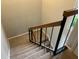 Carpeted staircase with wood and iron railing leading to the upper level at 4838 Pebble Beach Dr # A, Orlando, FL 32811
