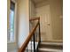 Carpeted stairway with a wooden handrail leading to the upper level at 4838 Pebble Beach Dr # A, Orlando, FL 32811