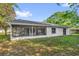Home exterior featuring a screened patio with natural light and backyard space at 4918 Gifford Blvd, Orlando, FL 32821