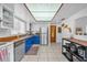 Functional kitchen with blue lower cabinets, butcher block countertops, and stainless steel appliances and abundant natural light at 4918 Gifford Blvd, Orlando, FL 32821