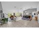 Bright, open-concept living room featuring neutral tones, tile flooring, and large windows for natural light at 4918 Gifford Blvd, Orlando, FL 32821
