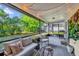 Screened-in patio with cozy seating and string lights, perfect for outdoor enjoyment and relaxation at 4918 Gifford Blvd, Orlando, FL 32821