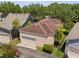 Aerial view of home featuring tile roof, two-car garage, and well-maintained landscaping at 5038 Fenwood Ln, Orlando, FL 32814
