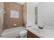 Bathroom with tiled walls, bathtub and vanity with a mirror at 5038 Fenwood Ln, Orlando, FL 32814