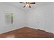 Bright bedroom with hardwood flooring, a ceiling fan, and shuttered windows at 5038 Fenwood Ln, Orlando, FL 32814