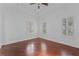 Bright bedroom featuring hardwood floors, shuttered windows, and ceiling fan at 5038 Fenwood Ln, Orlando, FL 32814
