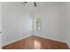 Bedroom featuring hardwood flooring, a ceiling fan, and shuttered windows at 5038 Fenwood Ln, Orlando, FL 32814