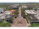 Aerial community shot featuring palm tree-lined street with a fountain and mixed-use commercial and residential buildings at 5038 Fenwood Ln, Orlando, FL 32814